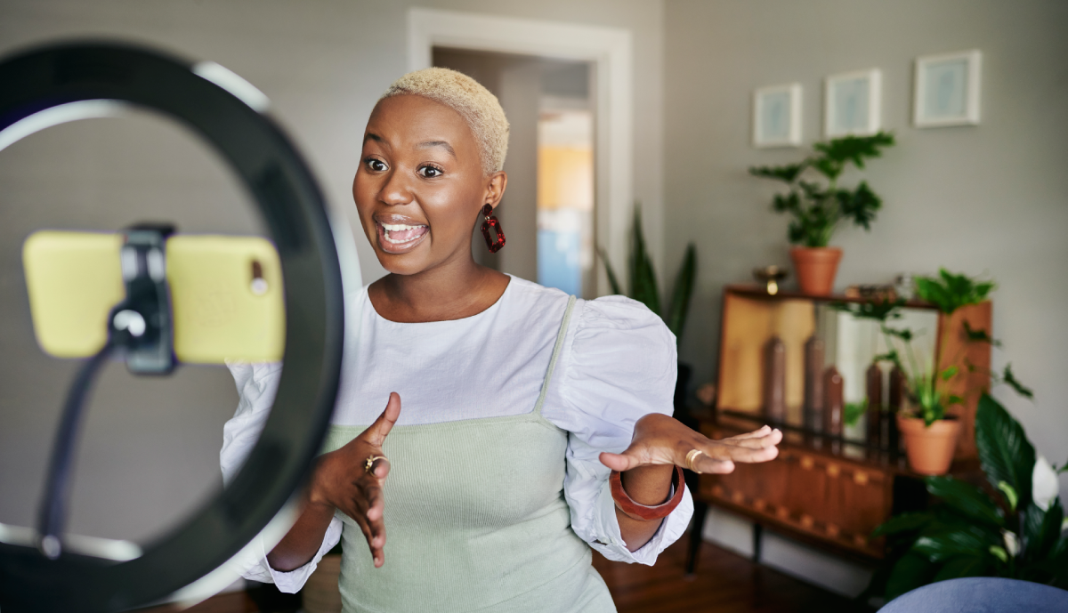 Female social media influencer recording on phone