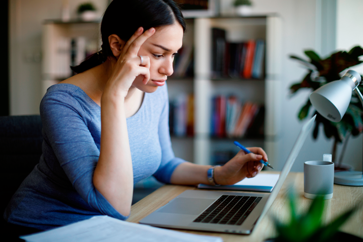 Woman reading laptop information